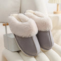 Women's brown plush indoor slippers with a round toe, flat heel, and a textured PVC sole.