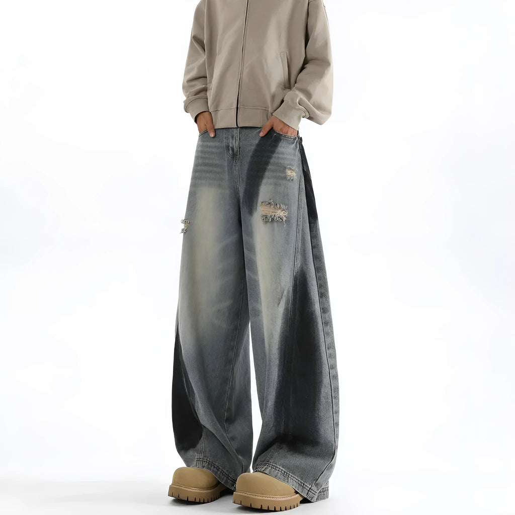 Men's blue distressed jeans with splash-ink patterns and rips in loose fit American style