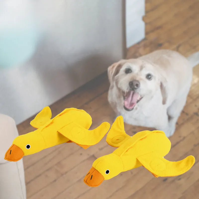 Yellow rubber duck dog toy with squeaker and treat compartment for puppy training and teething.