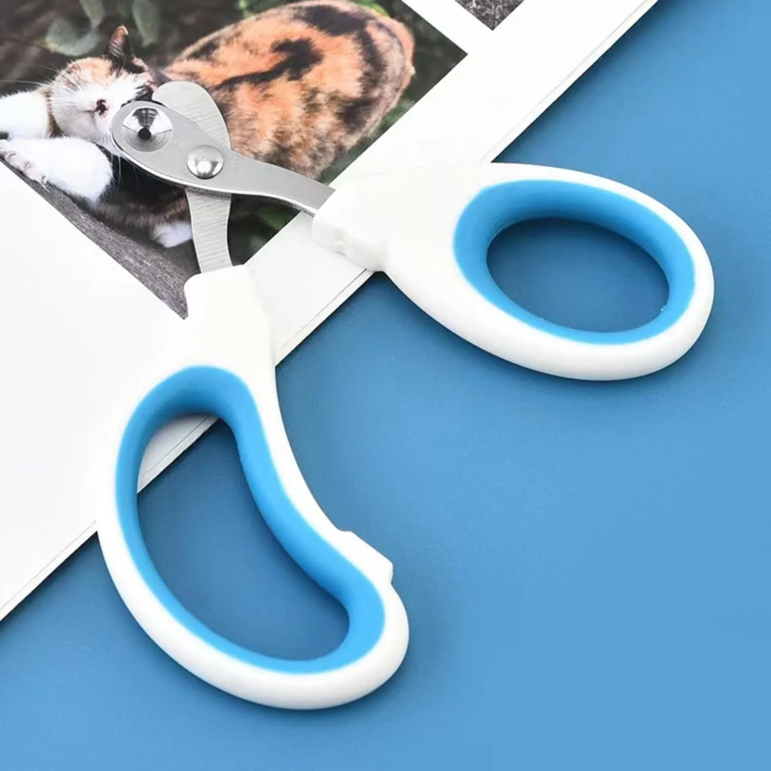 Blue handled cat nail clippers with circular cut hole showing stainless steel blade and non-slip grip.
