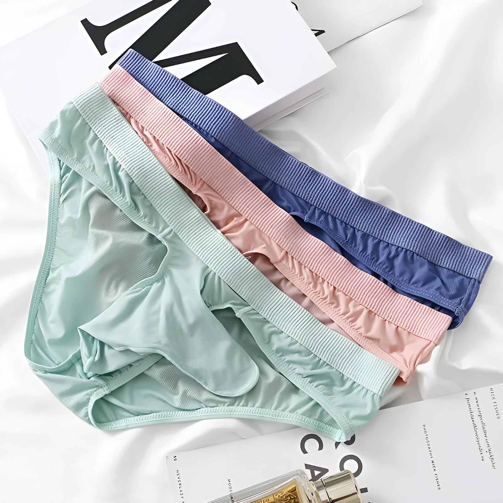 Men's low waist briefs underwear in Ice Silk fabric on a size chart showing weights for S, M, L, and XL.