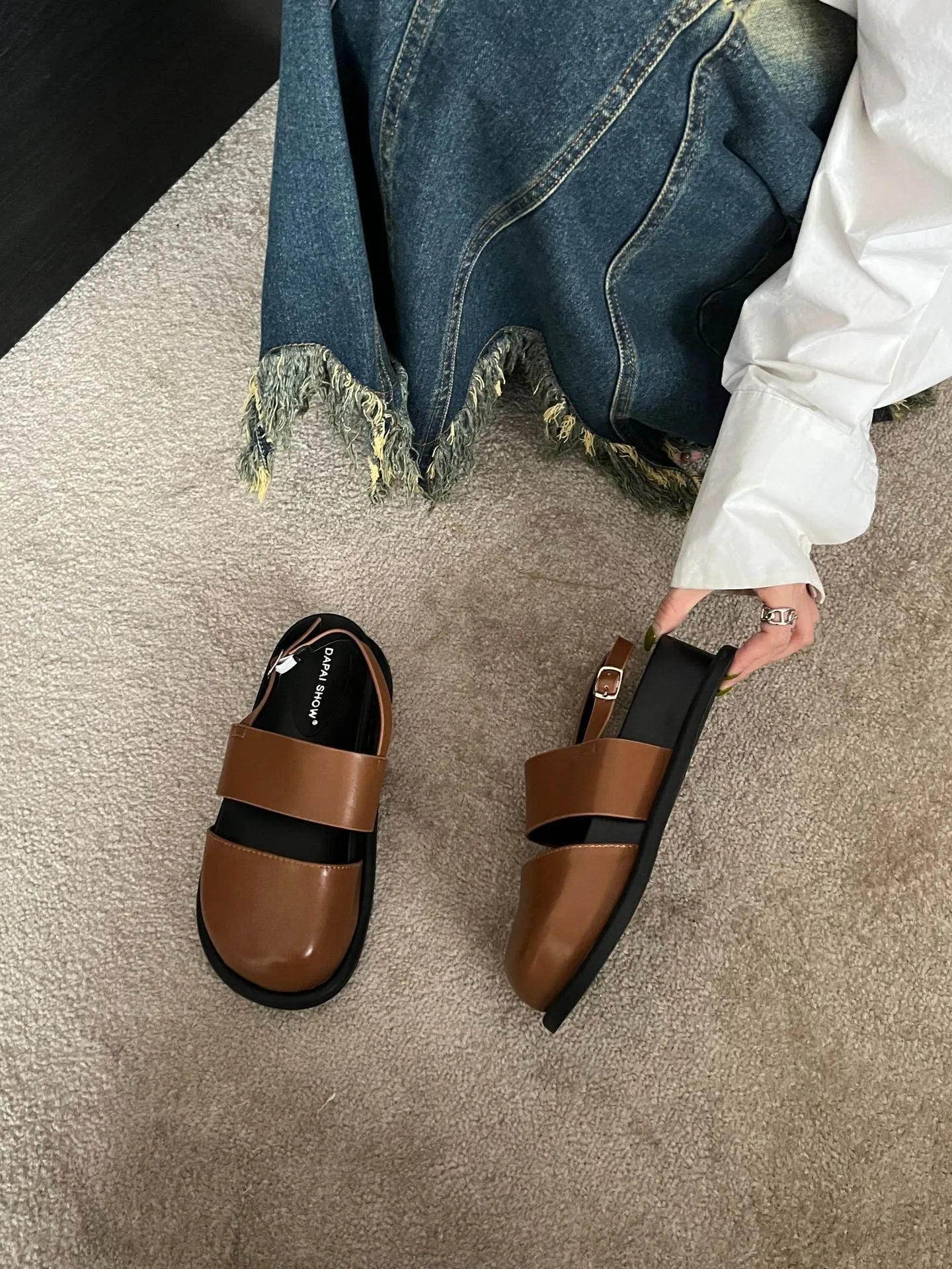 Korean style women's retro sandals with a black microfiber upper and adjustable ankle buckle on a PVC sole.