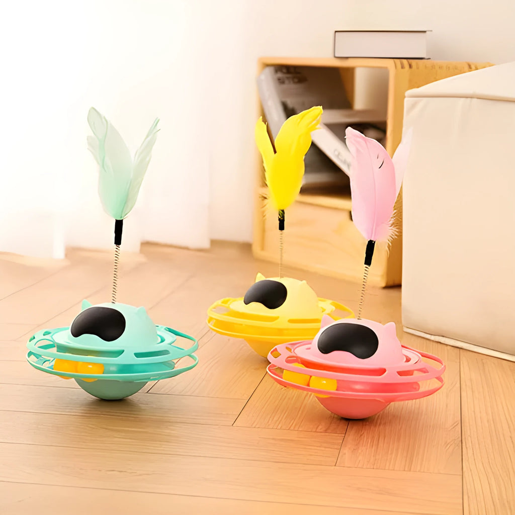 Pink rotating cat tumbler toy measuring 17 by 10 centimetres on a flat surface