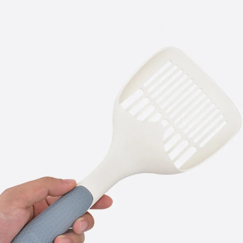 Large white plastic cat litter shovel for scooping clumping tofu cat litter.