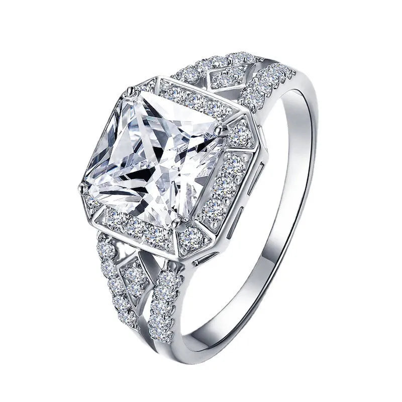 Women's platinum colour geometric zircon ring with hollow quadrilateral design on a copper band.