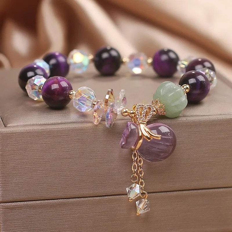 Women's forest style bracelet with purple tiger eye money bag pendant and rhinestone crystal details