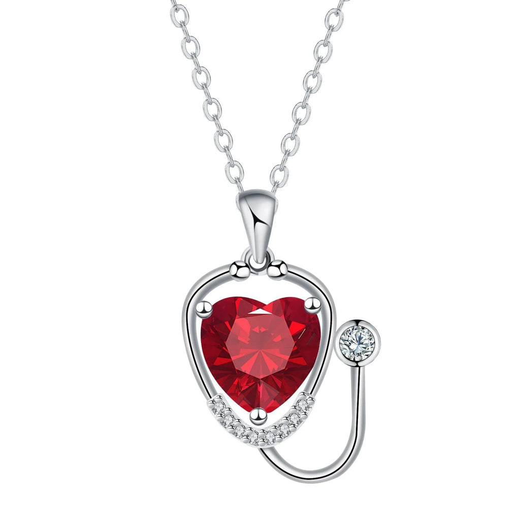 Red diamond women's necklace with stethoscope, wing, and cross pendant design on a copper chain.