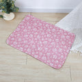 Reusable waterproof pet training pad with animal print design, shown in multiple sizes on a floor.
