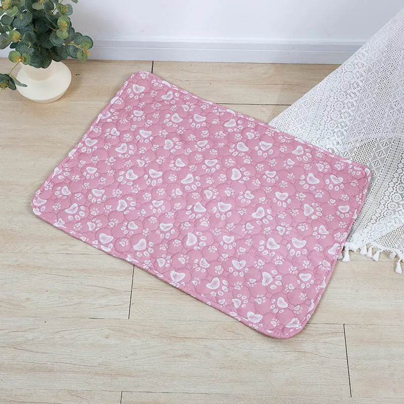 Reusable waterproof pet training pad with animal print design, shown in multiple sizes on a floor.