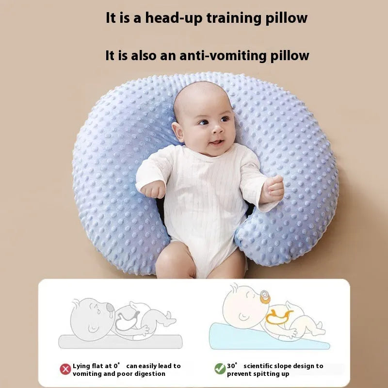 Grey nursing pillow for breastfeeding with removable cover on a neutral background