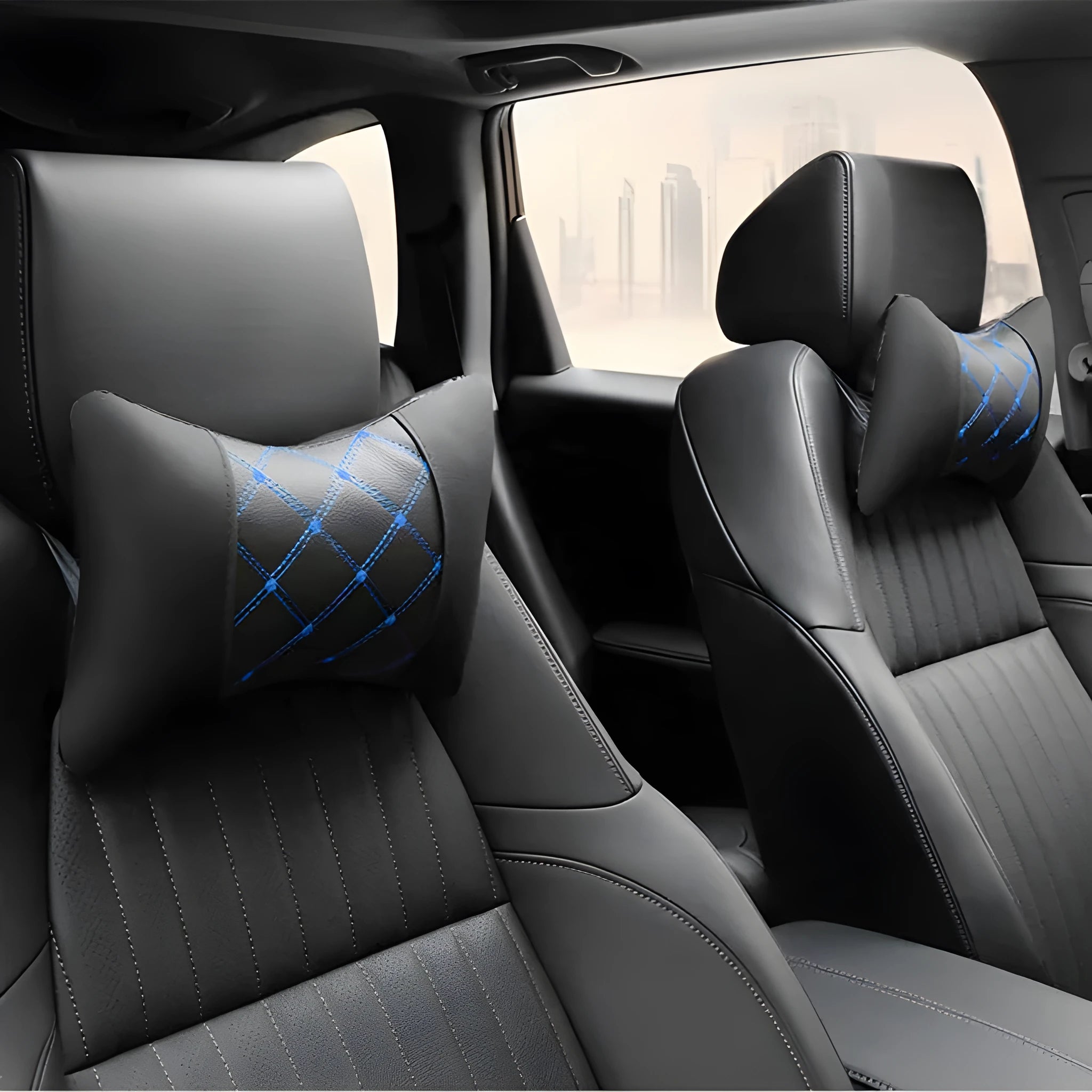 Pair of black diamond-quilted car headrest pillows with blue stitching for neck support.