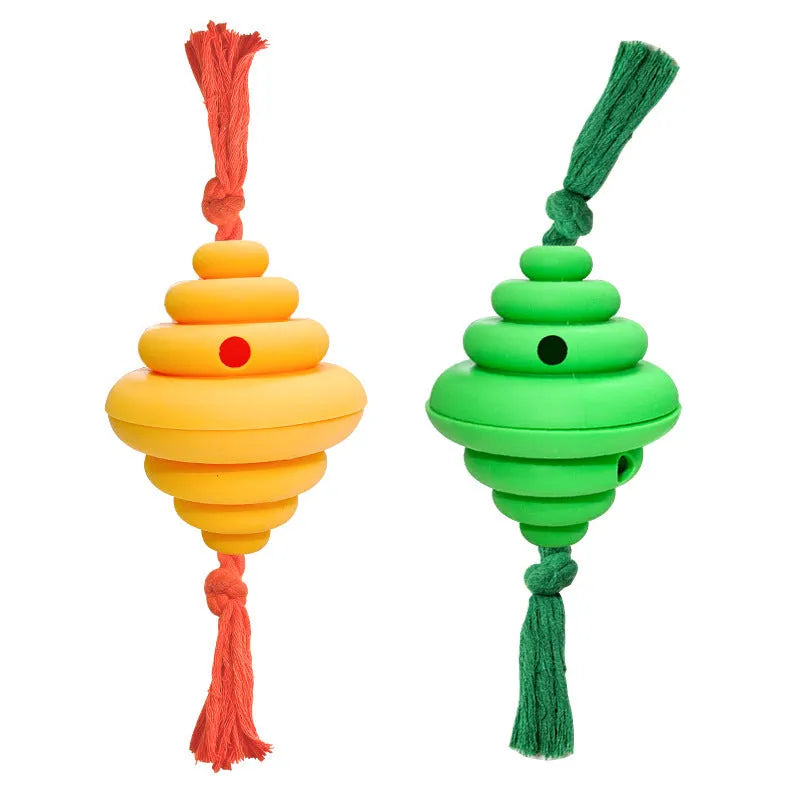 Green and yellow silicone dog ball with knotted rope attached, showing food dispenser openings.