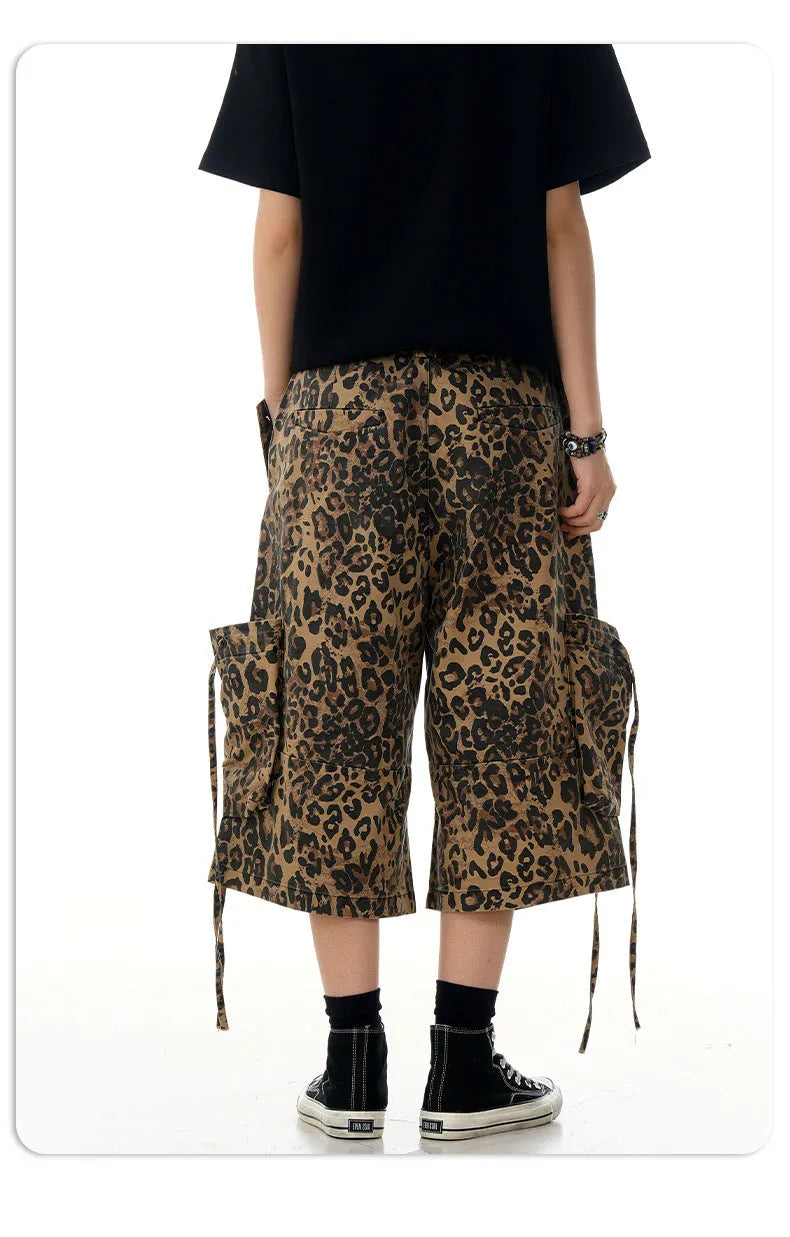 Women's high-waisted leopard print cropped trousers with a loose straight leg and button fly.