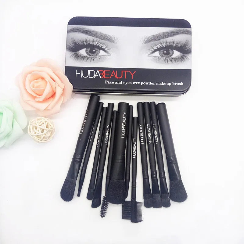 12 black makeup brushes in a tin box with nylon bristles and wooden handles on a white background