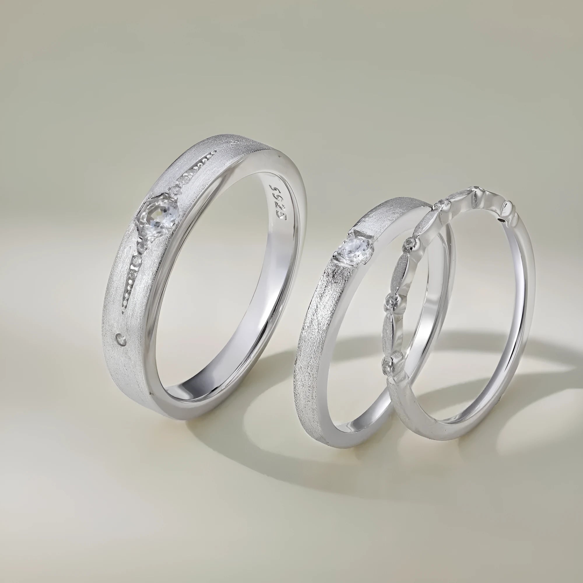 Sterling silver couple ring with geometric round diamond inlay in white gold finish on neutral background