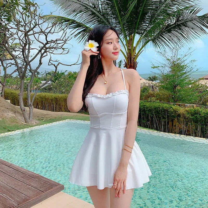 White women's one-piece swimsuit with hollow out design detail for swimming