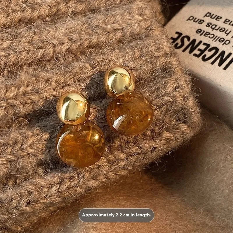 Three pairs of handmade geometric holiday earrings with tassel details in alloy with electroplated finish