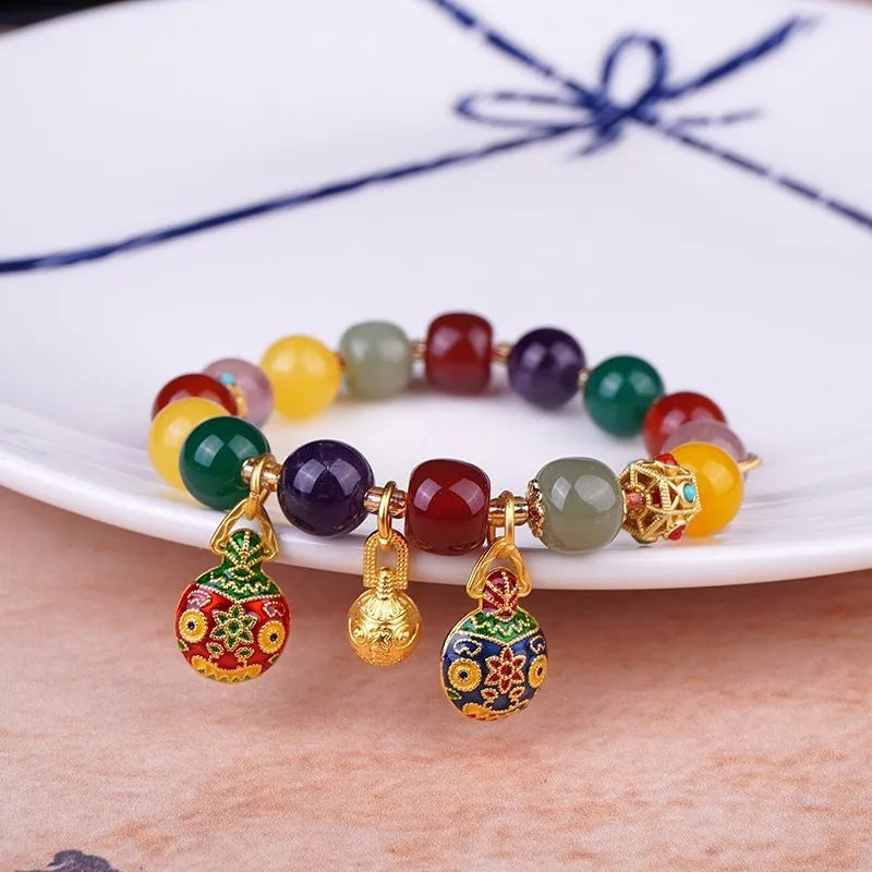 Hand-woven agate bracelet with 10mm swallowing gold beast beads on display