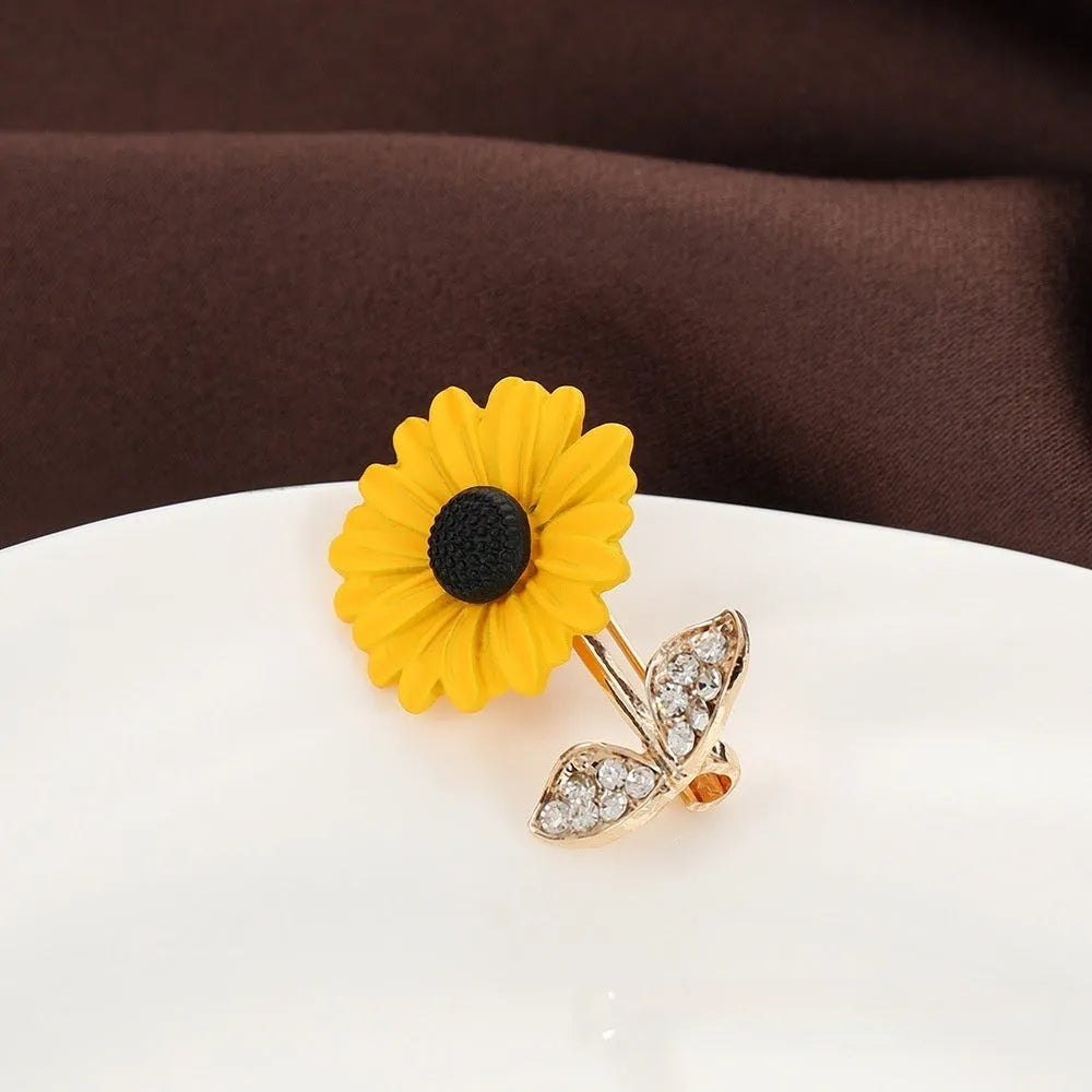 Close-up of a sunflower brooch pin for women, alloy electroplated finish, 2.4 cm by 3.1 cm size