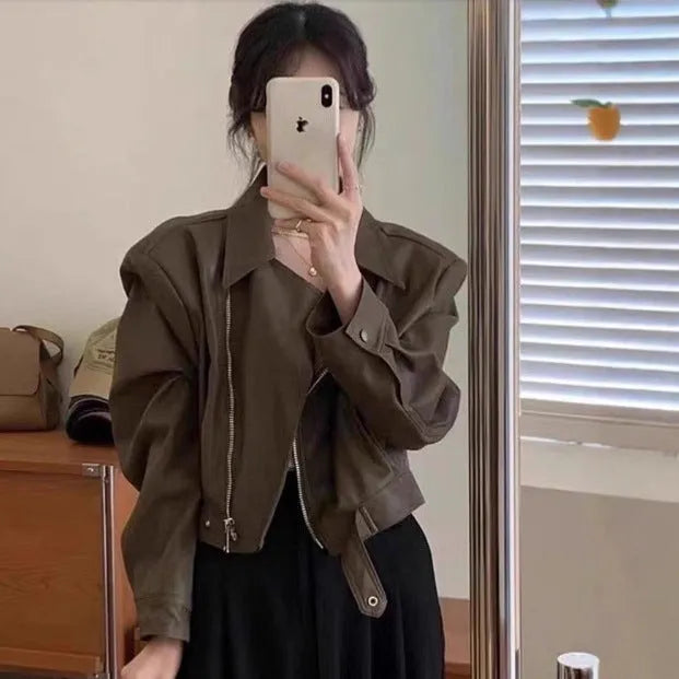 Brown women's retro slim-fit imitation leather jacket with pockets on a model.