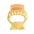 Shell-shaped plastic pet grooming brush with curved wire bristles and anti-slip handle