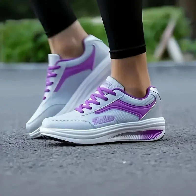 Women's grey pink mid-heel heelless sports travel shoes on a white background.