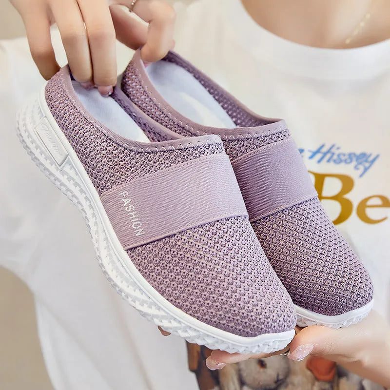 Women's breathable mesh casual shoes in black with a round toe, flat heel, and hollow out design detail.