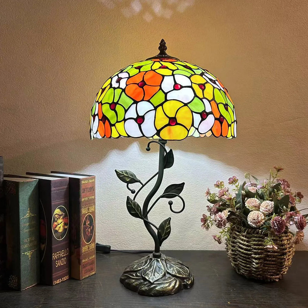 American Pastoral Tiffany 12-inch table lamp with coloured glass shade and resin base, 30 cm wide