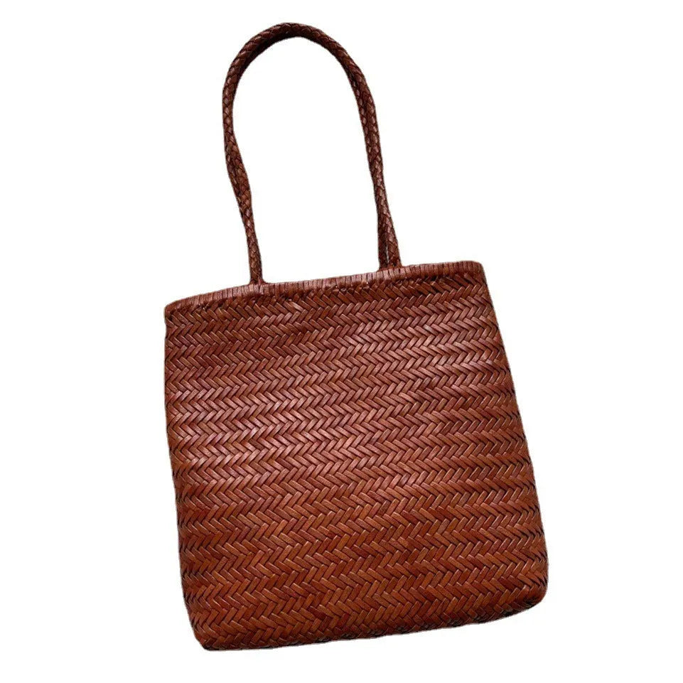 Brown vintage woven leather tote bag with a three-dimensional front pocket.