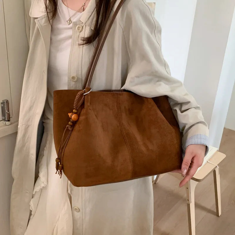 Large suede tote bag in brown with matching pendant, horizontal square shape, single shoulder strap, and retro styling