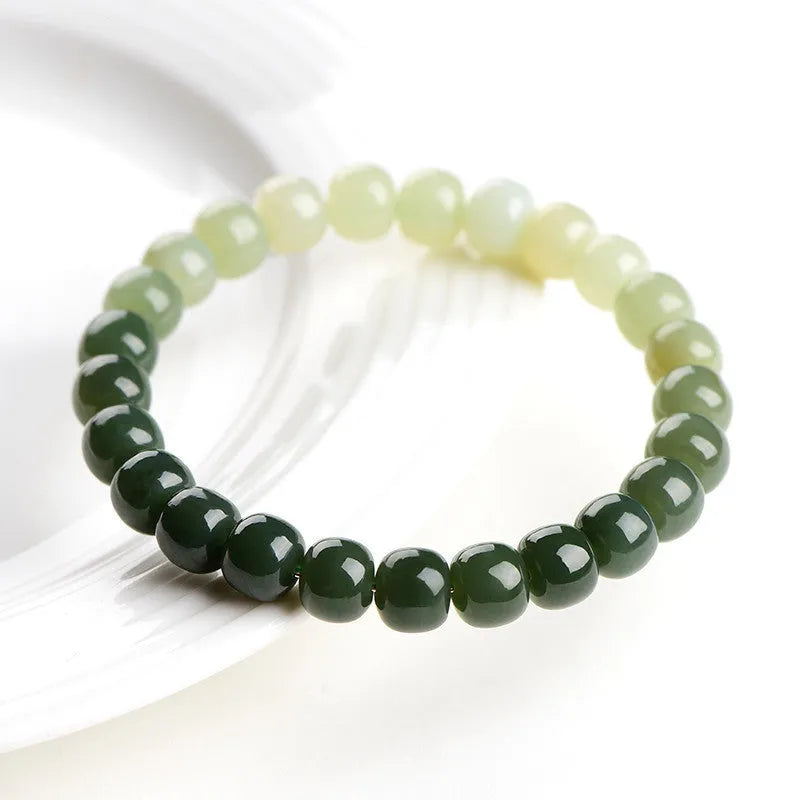 Natural Hetian jade bracelet with gradient clear water colours on wrist.