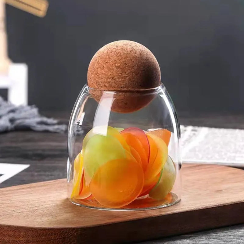 Three transparent glass spherical food storage tanks arranged on a shelf with modern simple design