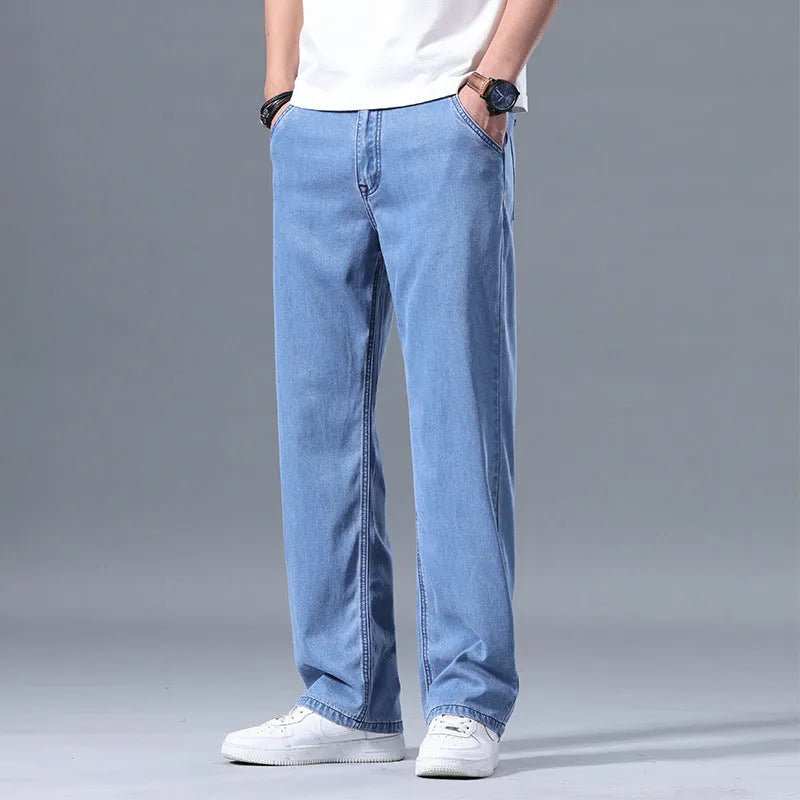Men's loose straight-leg lyocell jeans in blue and grey colour options showing zip fly detail