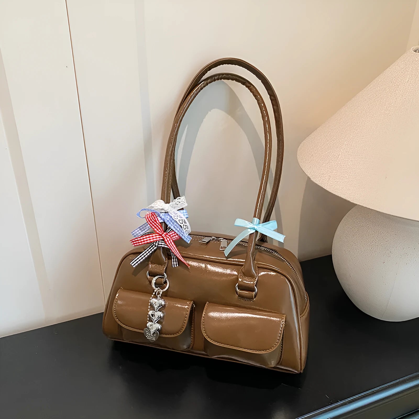 Retro brown PU leather pillow-shaped women's handbag with double straps and a flap closure.