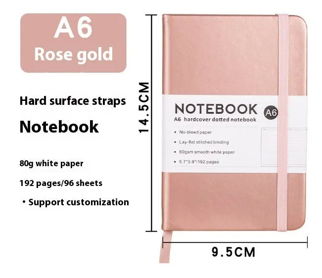 A5 size notebook with soft skin-feel PU leather cover and strap closure, open to show horizontal lined pages.