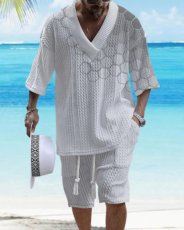 Man wearing a printed drop-shoulder knitted short-sleeved top with matching shorts from a casual two-piece set.