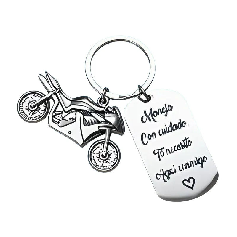 Stainless steel motivational keychain for motorcycle keys with a flannel storage bag.