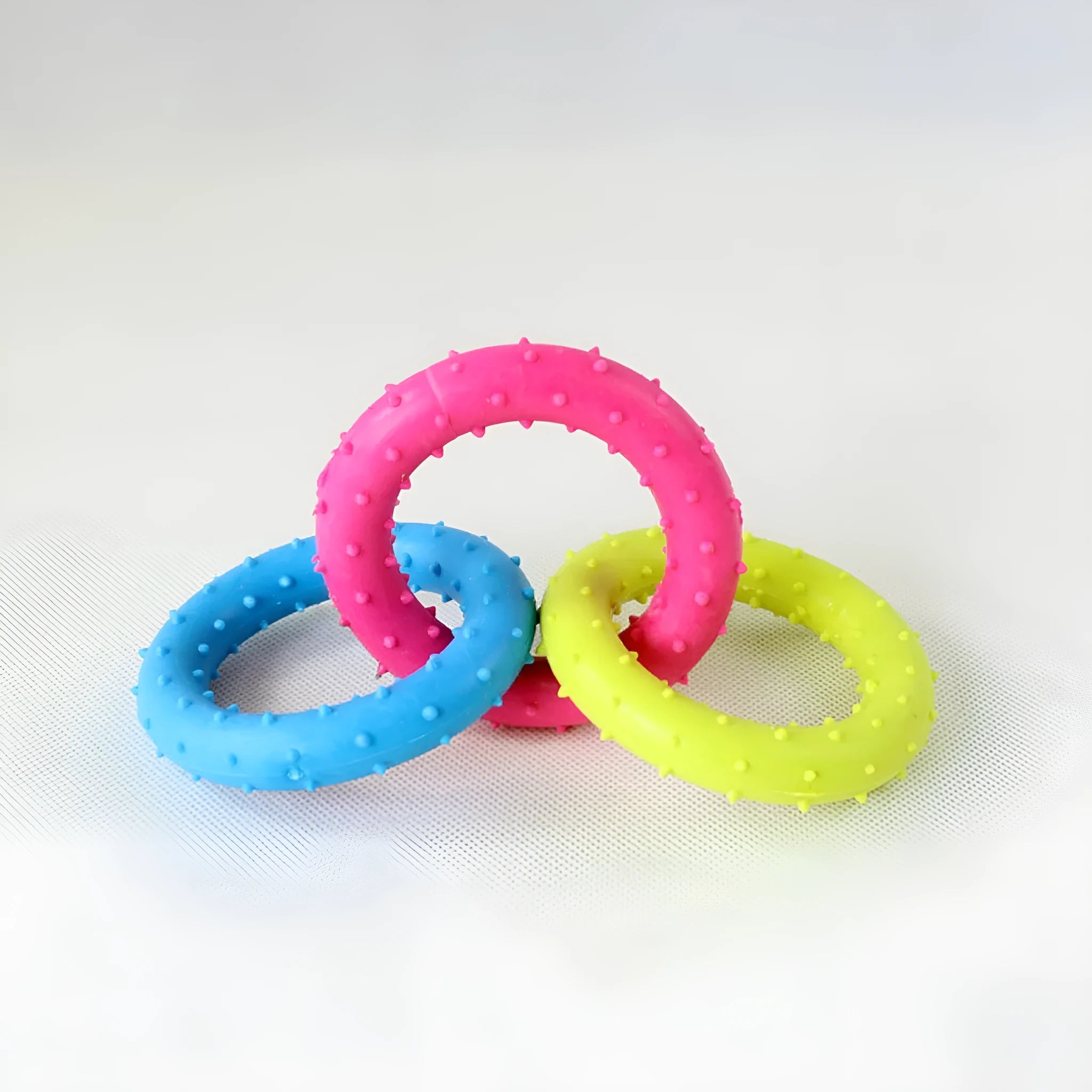 Three-chain TPR rubber dog molar toy for aggressive chewers shown in random colour