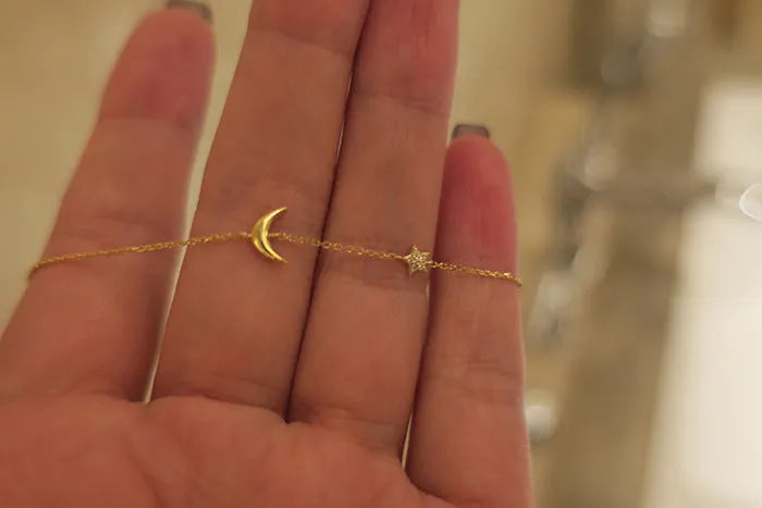 S925 sterling silver gold-plated moon and star bracelet on a white background, adjustable chain