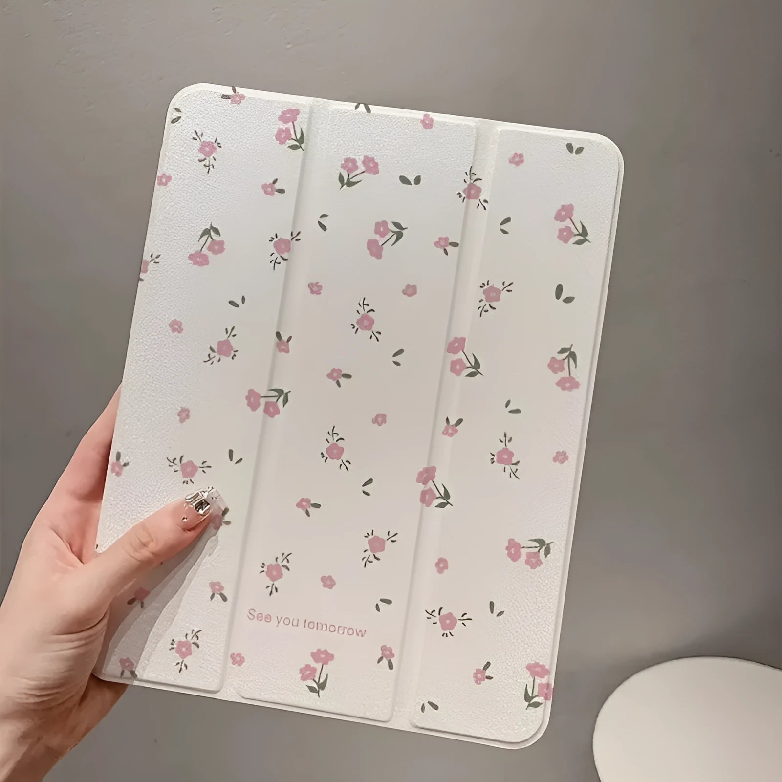 Transparent floral patterned iPad case showing three-fold magnetic stand positions