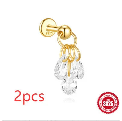 S925 sterling silver moon and star earrings with diamond accents on a gold-coloured background.