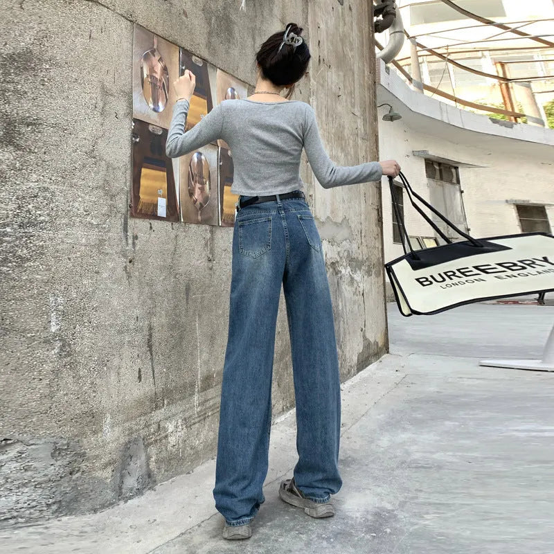 Woman wearing retro blue high-waisted straight-leg jeans in a cotton denim fabric.
