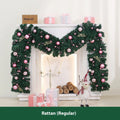 Long pink Christmas rattan garland with small decorative fruits and warm white LED lights draped on a mantelpiece.