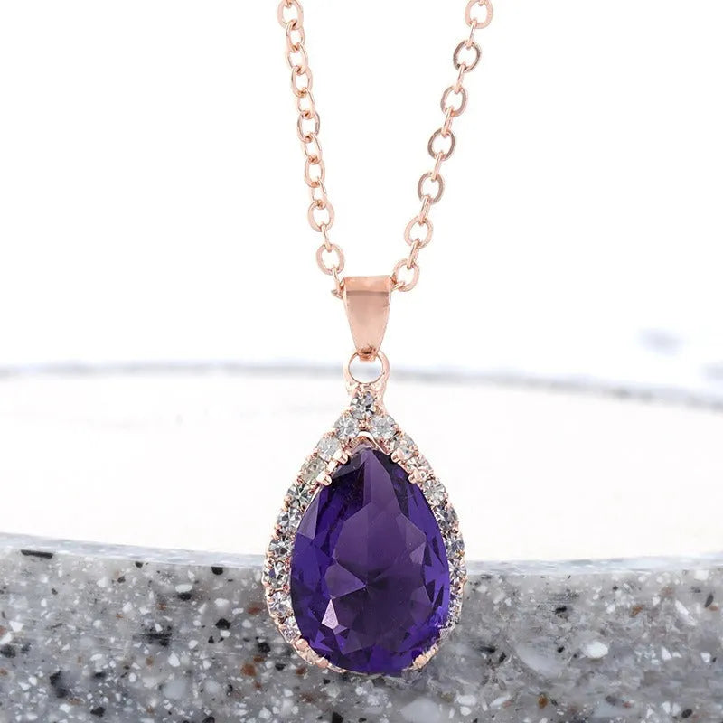 Women's water drop shaped pink necklace with rose gold rhinestone geometric detailing on alloy chain