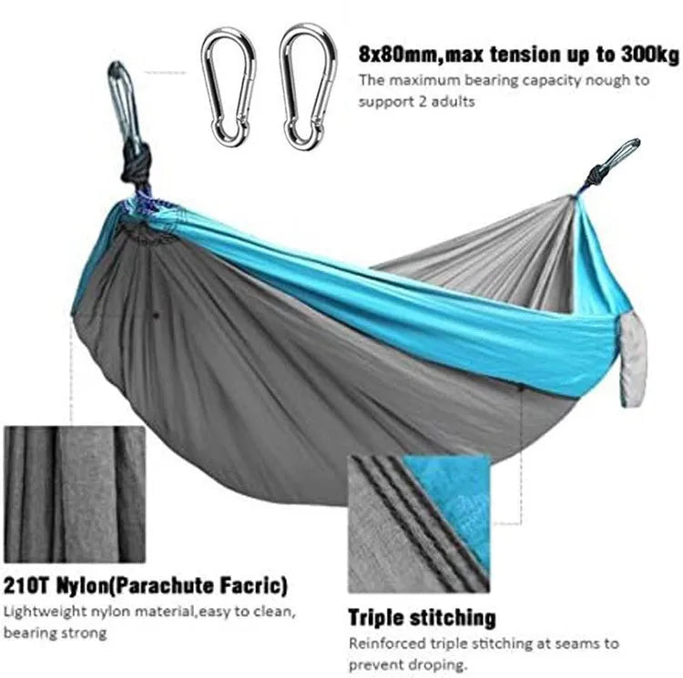 Sapphire blue parachute nylon camping hammock hung between two trees, showing its full 270cm length.