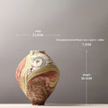 White ceramic decorative vase with hand-painted finish in modern simplicity style for tabletop display