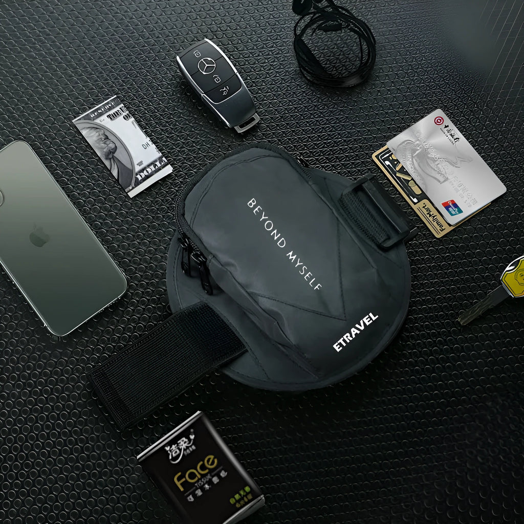 Black reflective running arm bag with adjustable strap, holding a mobile phone, shown on a runner's arm.