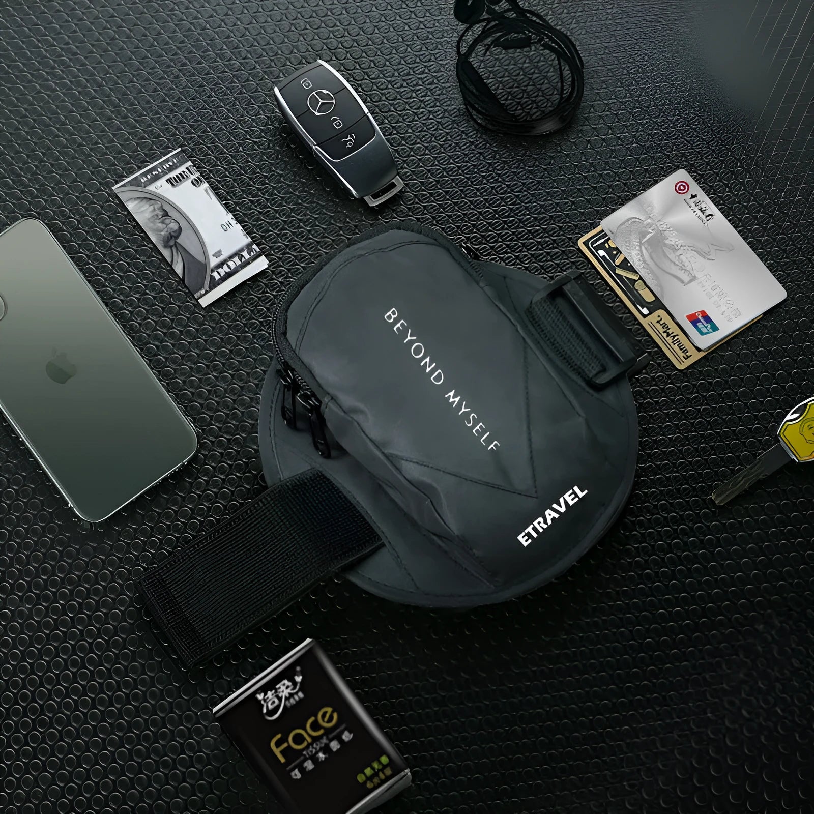 Black reflective running arm bag with adjustable strap, holding a mobile phone, shown on a runner's arm.