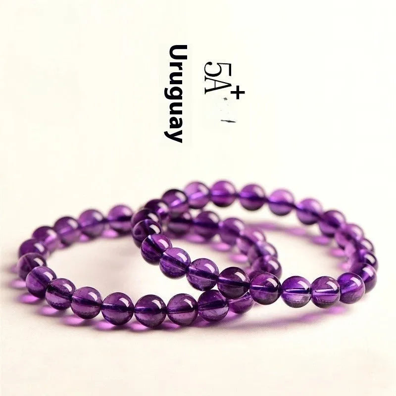 Natural Uruguayan amethyst scattered bead bracelet on wrist, showing polished purple crystal beads.