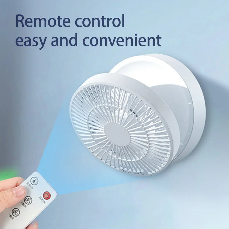 White portable folding electric fan with remote control and warm night light on a desk.